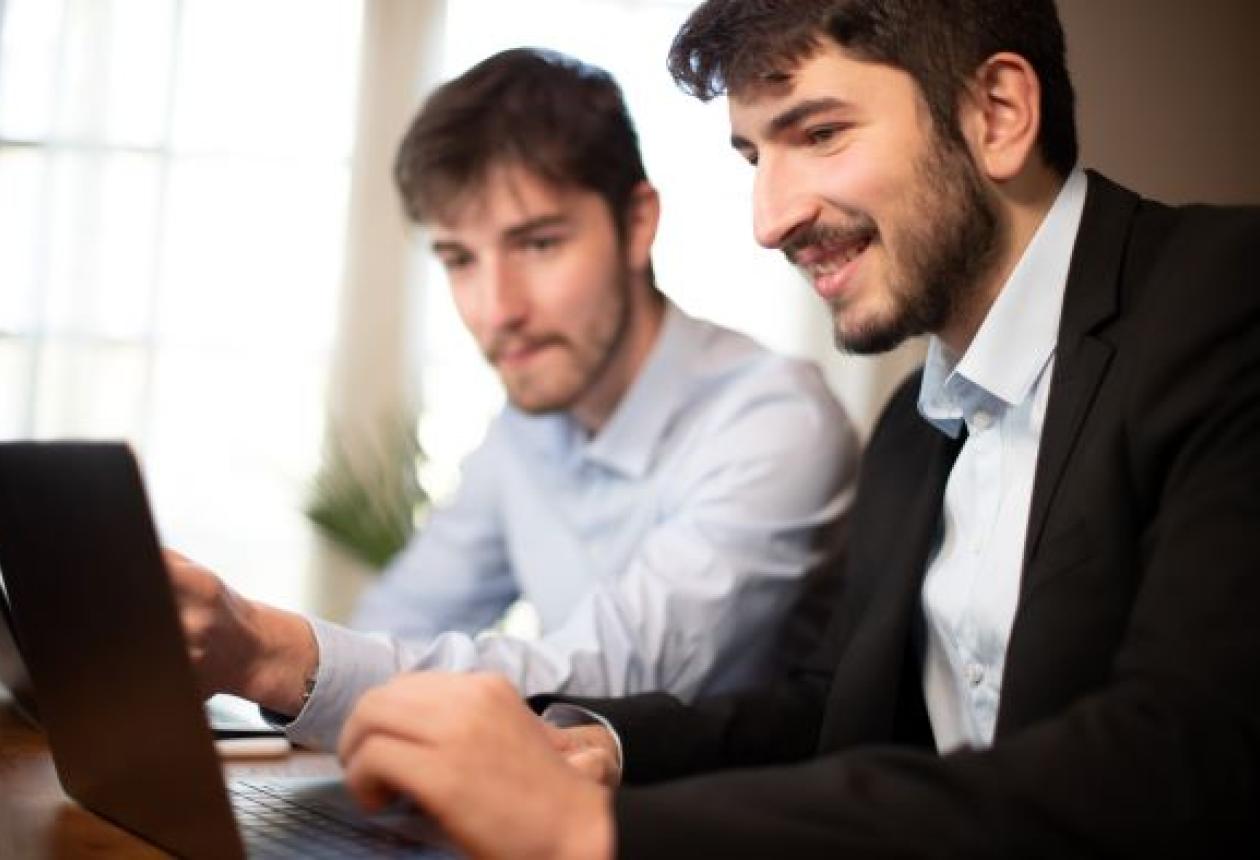 deux jeunes employés de bureau ou hommes d'affaires travaillent ensemble avec des ordinateurs portables